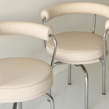 two ivory colored round chairs