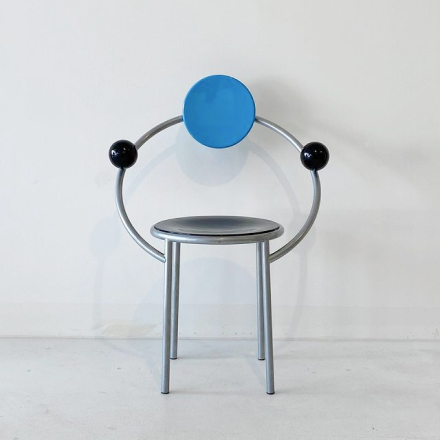 a chair with unique back and armrest