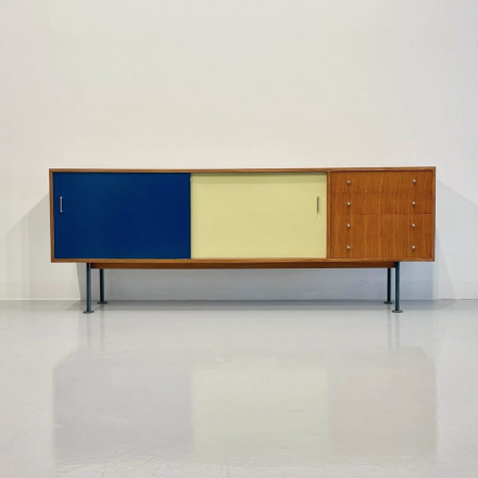 a low cabinet with blue and ivory doors