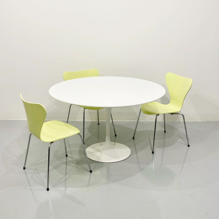 three lemon colored chairs and a white table