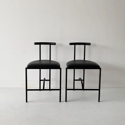 two unique designed black chairs 