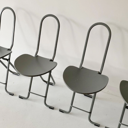 four unique designed grey chairs